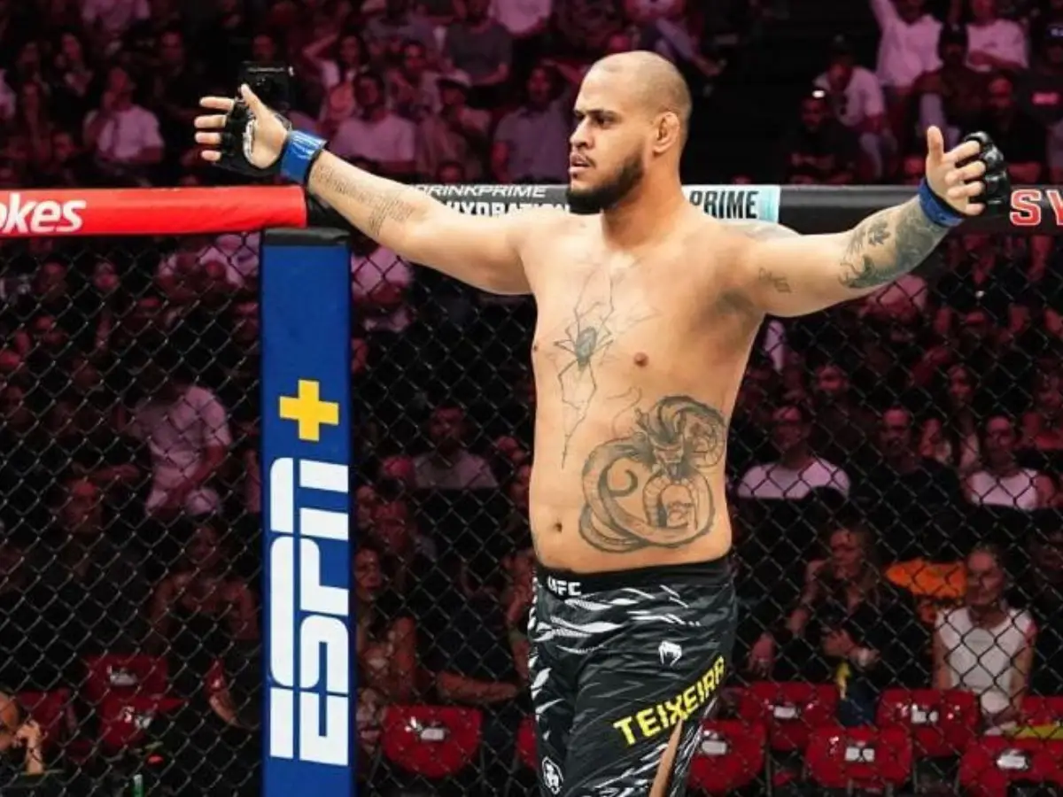 Lutador brasileiro Xicão, peso-pesado do UFC, dentro do octógono de braços abertos após vitória, diante do público na arena em Sydney, durante o UFC 325